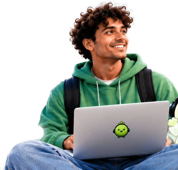 A smiling man in a green hoodie working on his laptop